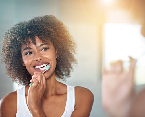 A woman brushing her teeth.